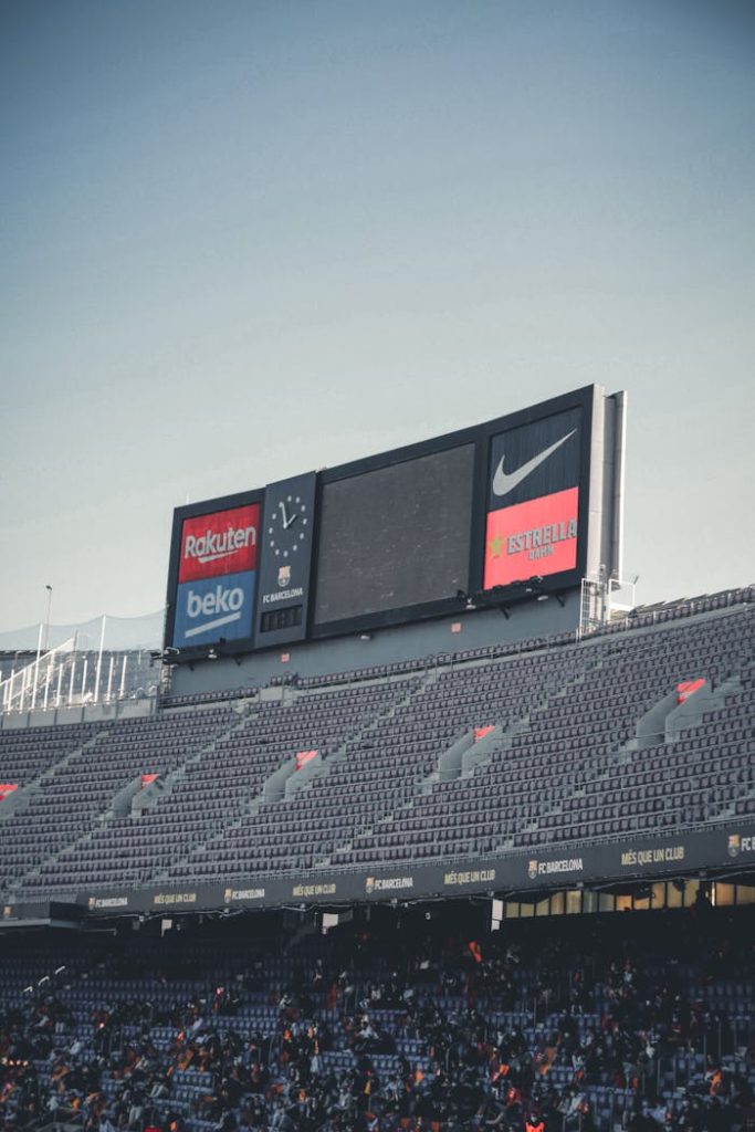 Signage in Stadium Under White Sky